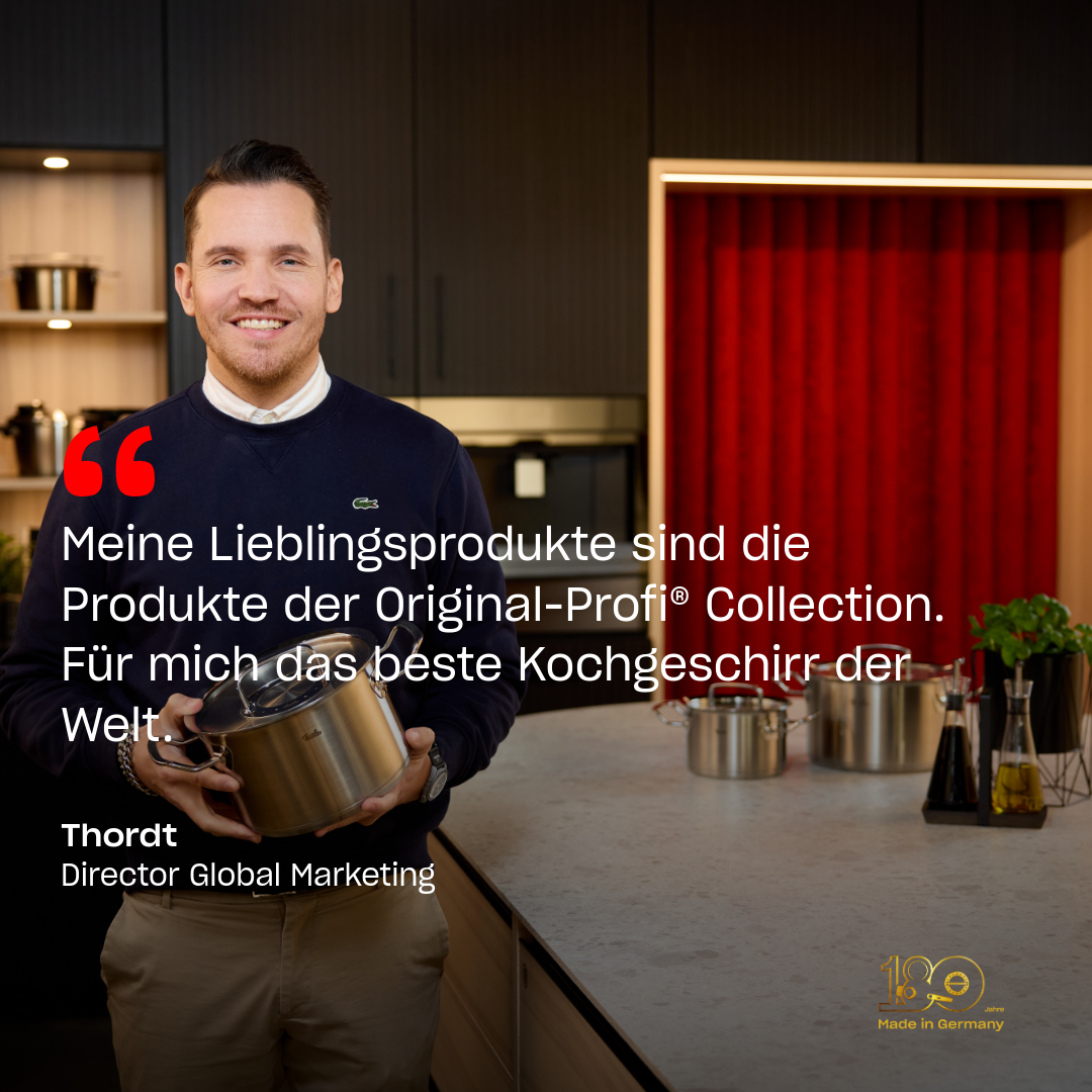 A smiling man in an elegant kitchen holds a Fissler pot; high-quality cookware and his quote in German emphasize "Made in Germany" quality.